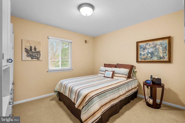 bedroom with light colored carpet