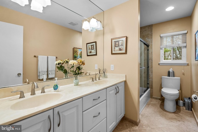 full bathroom with enclosed tub / shower combo, vanity, toilet, and tile patterned floors