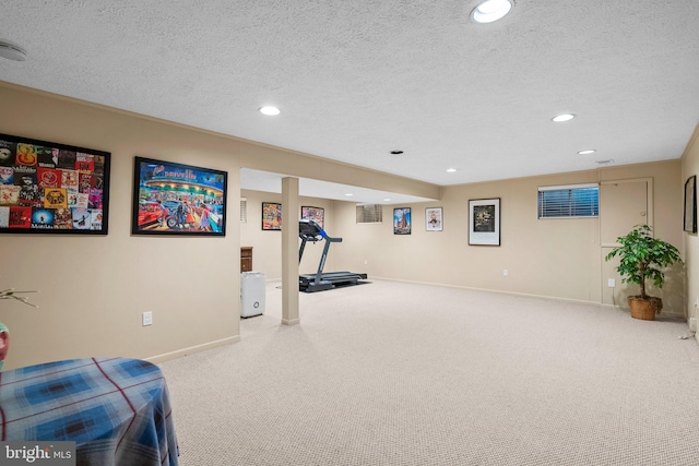 exercise room with carpet and a textured ceiling