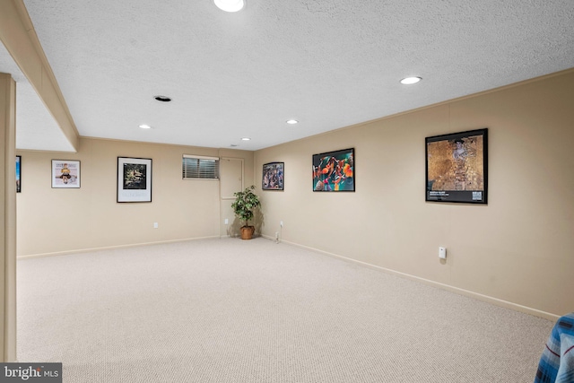 basement with carpet and a textured ceiling