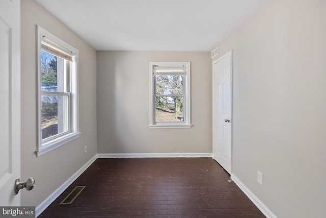 unfurnished room featuring dark hardwood / wood-style flooring