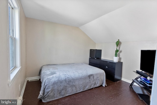 bedroom featuring dark colored carpet and vaulted ceiling