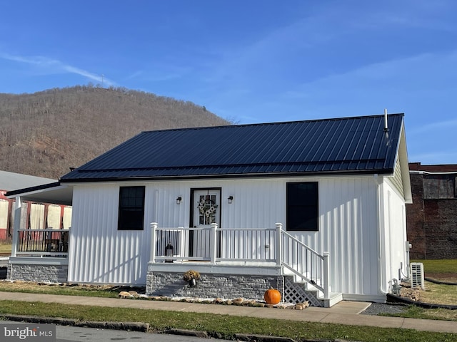 view of front facade with covered porch and central air condition unit