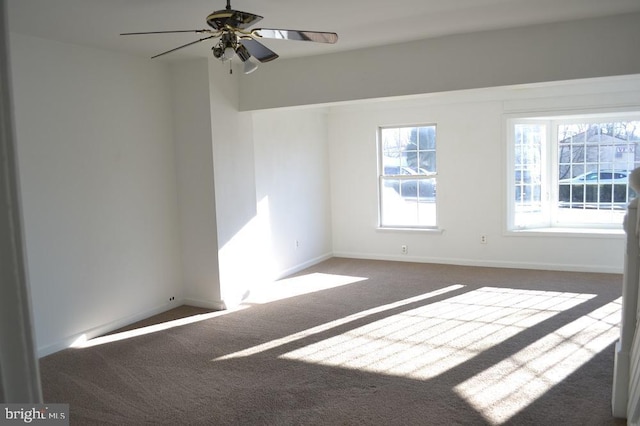 unfurnished room featuring dark colored carpet and ceiling fan