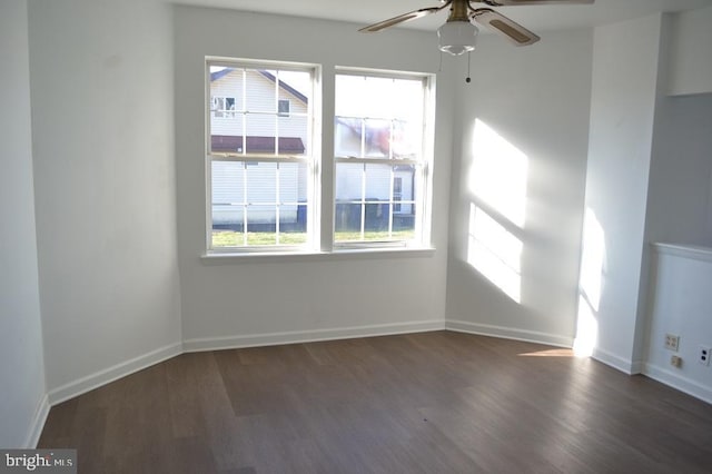 spare room featuring ceiling fan and dark wood-type flooring