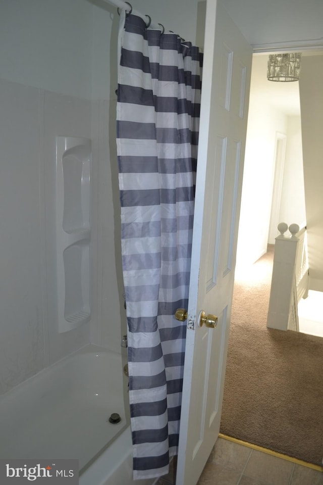 bathroom with shower / bath combo and tile patterned floors