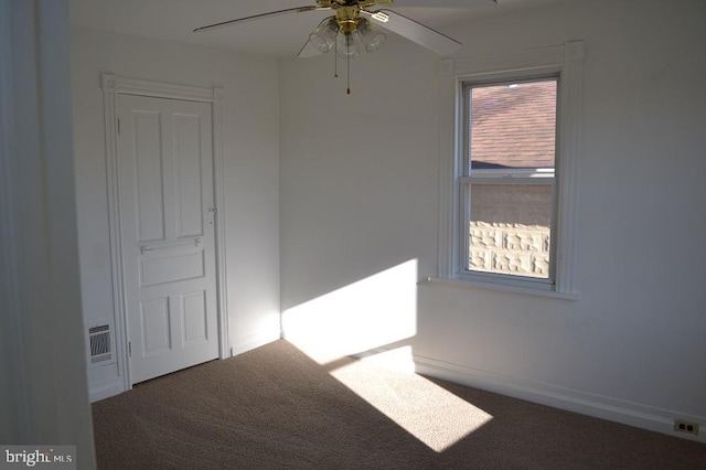 spare room featuring carpet floors and ceiling fan