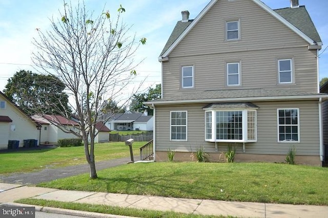 view of side of home featuring a yard