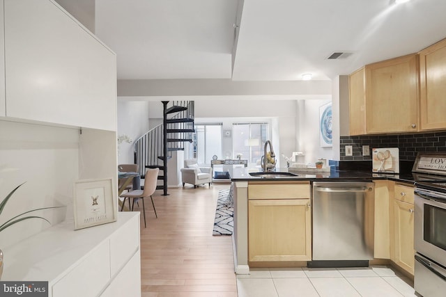 kitchen with light brown cabinets, light hardwood / wood-style floors, sink, and appliances with stainless steel finishes