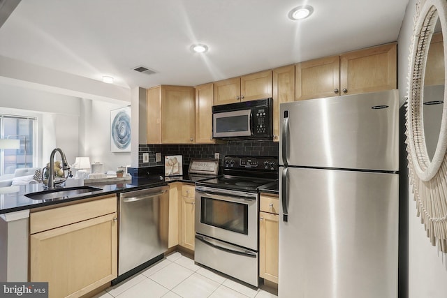 kitchen with sink, stainless steel appliances, and light brown cabinetry