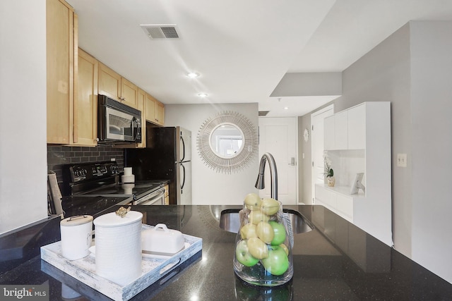 kitchen featuring tasteful backsplash, black range with electric stovetop, light brown cabinetry, and sink