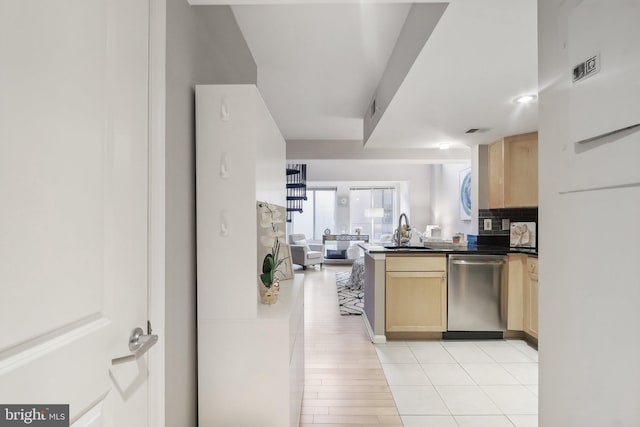 kitchen with sink, dishwasher, light brown cabinets, backsplash, and light wood-type flooring