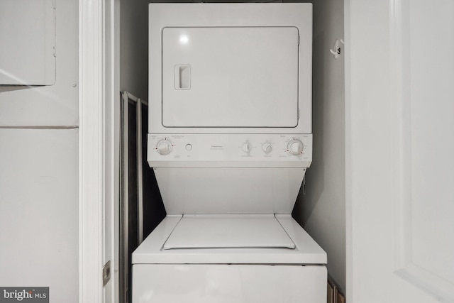 washroom featuring stacked washing maching and dryer