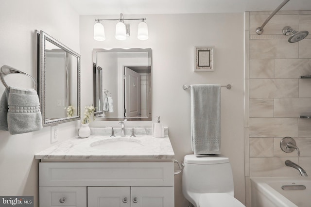 full bathroom with vanity, toilet, and tiled shower / bath combo