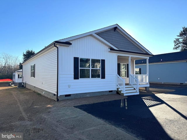 view of front of house with covered porch and central AC