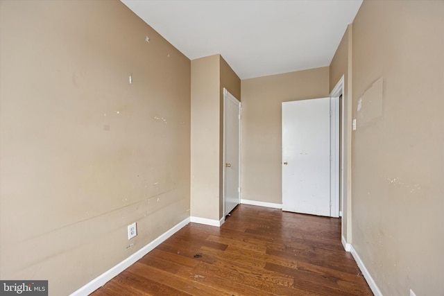 interior space with wood finished floors and baseboards