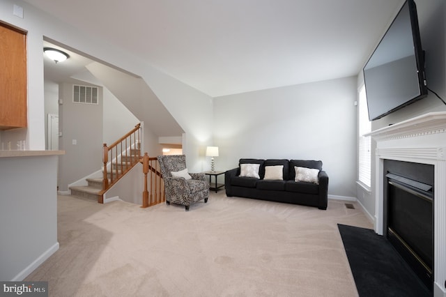 living room with light colored carpet and lofted ceiling