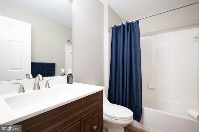 full bathroom featuring vanity, toilet, wood-type flooring, and shower / bath combo