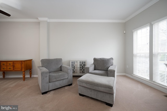 sitting room featuring light carpet, ceiling fan, and ornamental molding