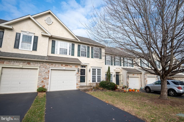 multi unit property featuring a garage