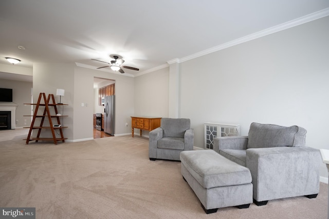 living area with ceiling fan, light colored carpet, and crown molding