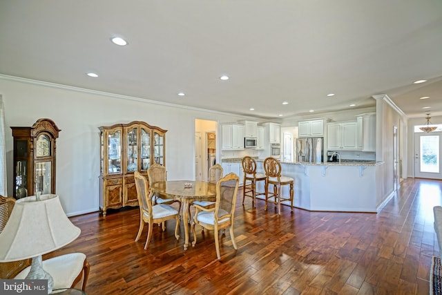 dining room with crown molding and dark wood-type flooring