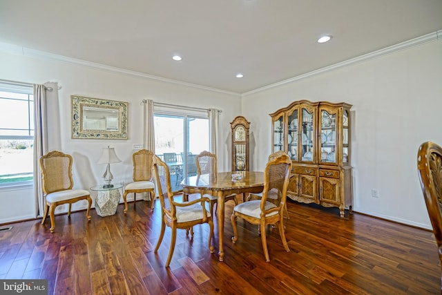 dining room featuring crown molding and dark wood-type flooring