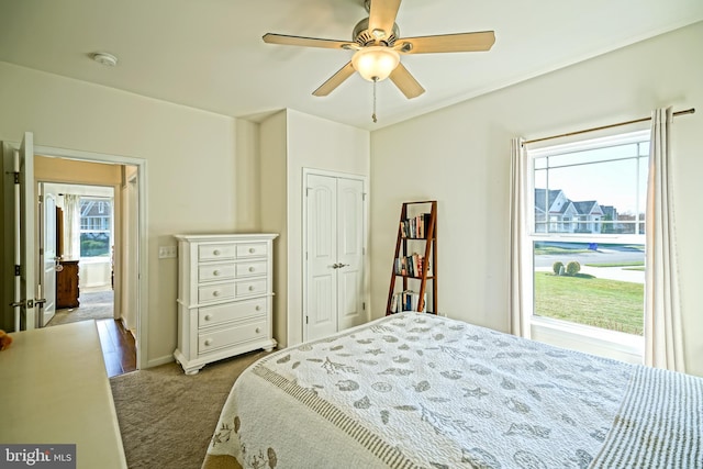 bedroom with light carpet, a closet, and ceiling fan