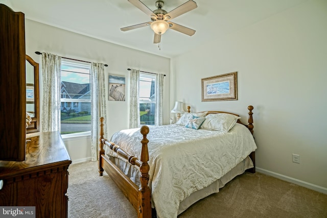 bedroom featuring light colored carpet and ceiling fan