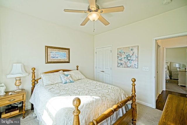 carpeted bedroom featuring ceiling fan and a closet