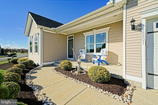 view of exterior entry with a porch