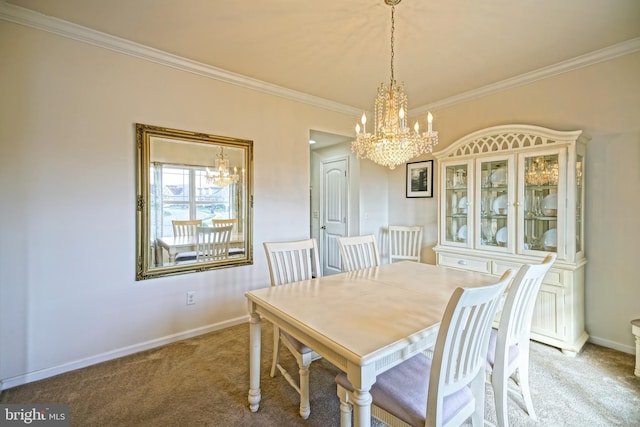 dining space featuring ornamental molding, carpet flooring, and a chandelier