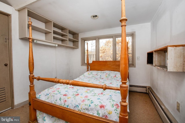 bedroom with carpet and a baseboard heating unit