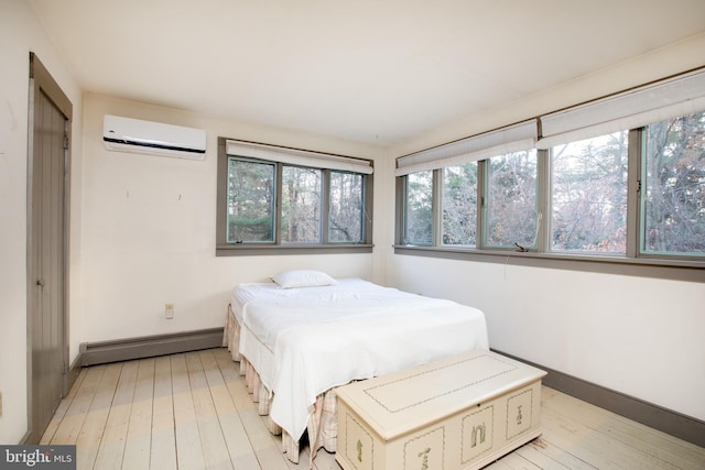 bedroom with light wood-type flooring, a wall unit AC, multiple windows, and a baseboard heating unit