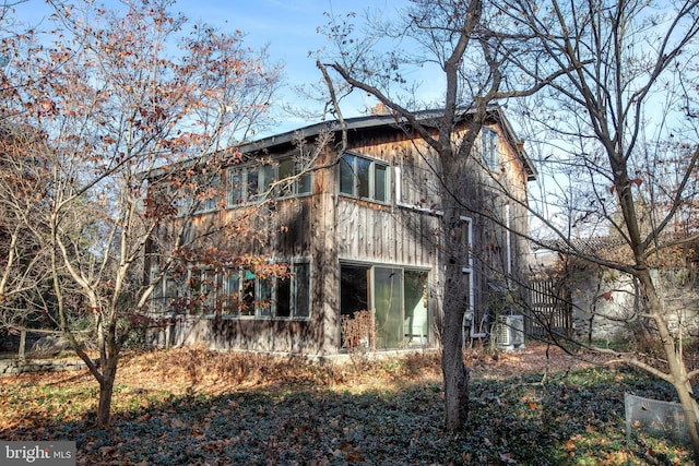 rear view of property featuring cooling unit