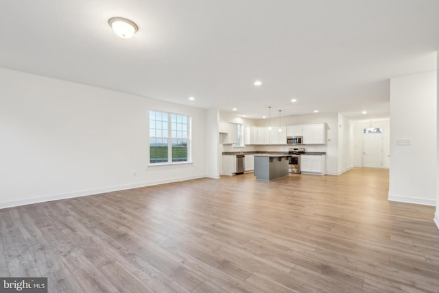 unfurnished living room with light hardwood / wood-style flooring