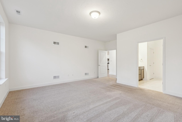 spare room with light carpet