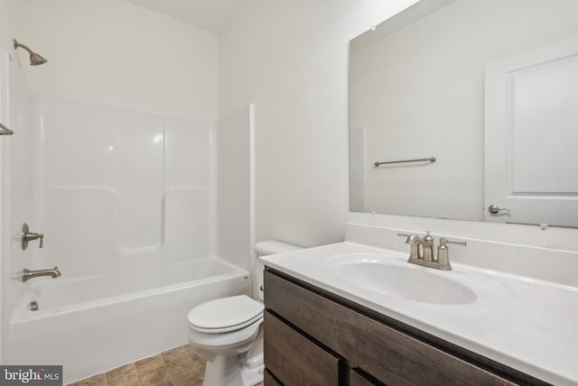 full bathroom featuring washtub / shower combination, vanity, and toilet