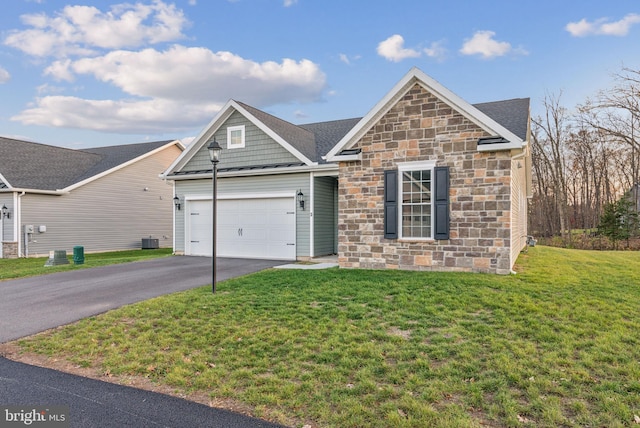 view of front of house with a garage and a front lawn