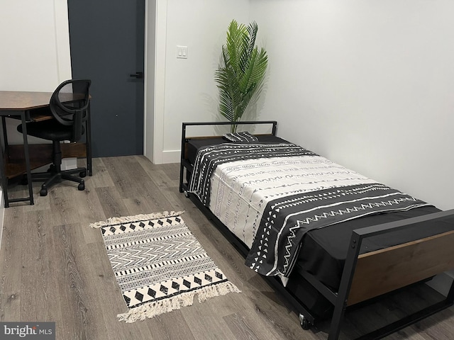 bedroom with dark wood-type flooring