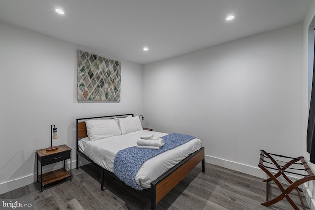 bedroom with hardwood / wood-style flooring