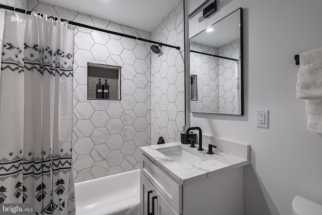 full bathroom featuring shower / tub combo with curtain, vanity, and toilet