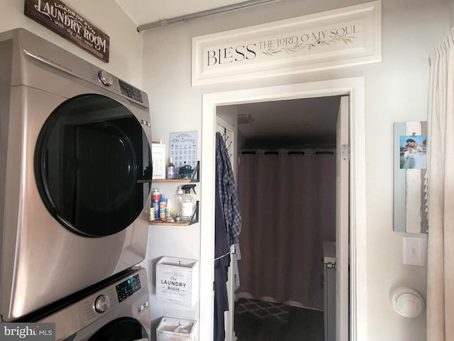 washroom with stacked washer / drying machine