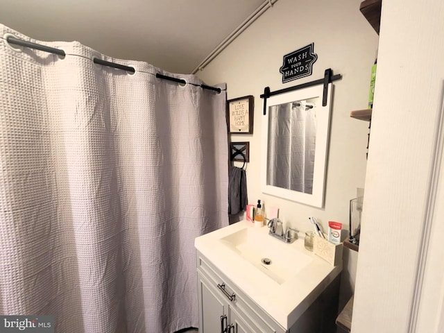 bathroom with vanity, walk in shower, and crown molding