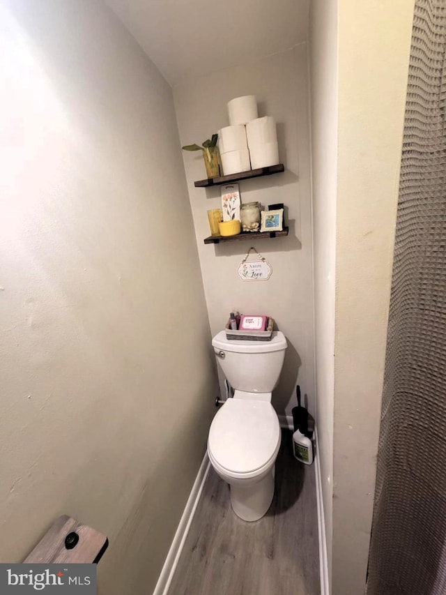 bathroom featuring hardwood / wood-style floors and toilet