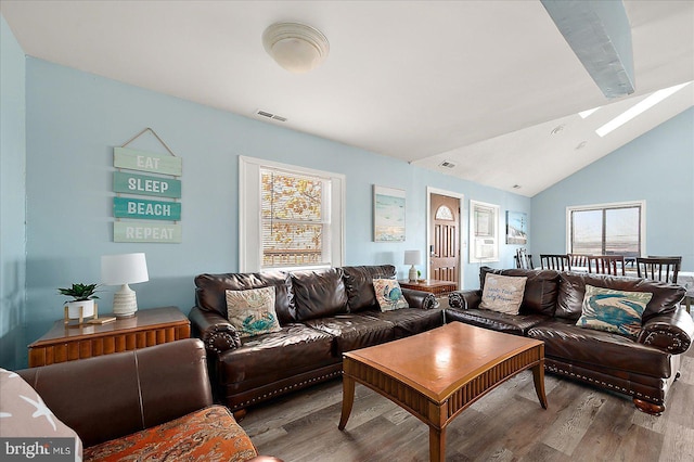 living room featuring light wood-type flooring and lofted ceiling