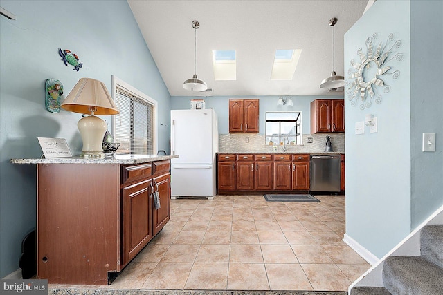 kitchen with stainless steel dishwasher, decorative light fixtures, white fridge, and sink