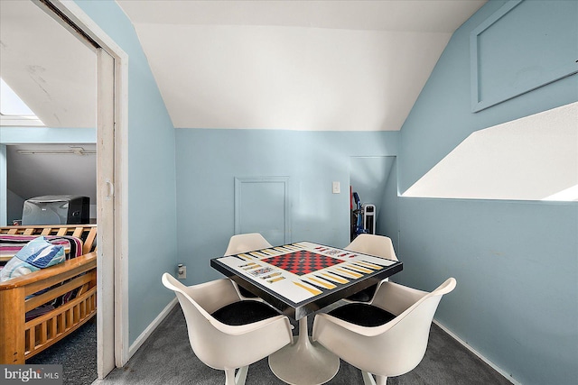 carpeted dining room with vaulted ceiling