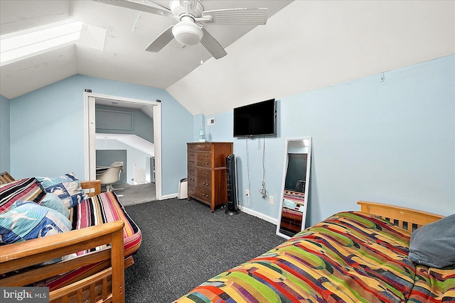 bedroom with ensuite bathroom, dark carpet, ceiling fan, and lofted ceiling