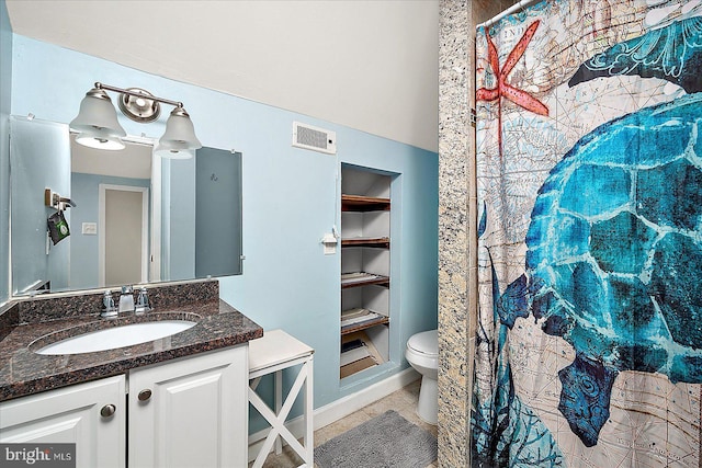 bathroom featuring tile patterned floors, vanity, and toilet